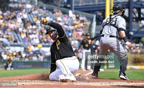 Jared Triolo of the Pittsburgh Pirates slides in safely to home plate to score on a RBI single by Liover Peguero in the third inning during the game...