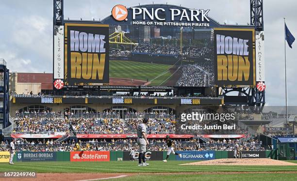 Carlos Rodon of the New York Yankees watches the video board as Miguel Andujar of the Pittsburgh Pirates rounds the bases after hitting a solo home...