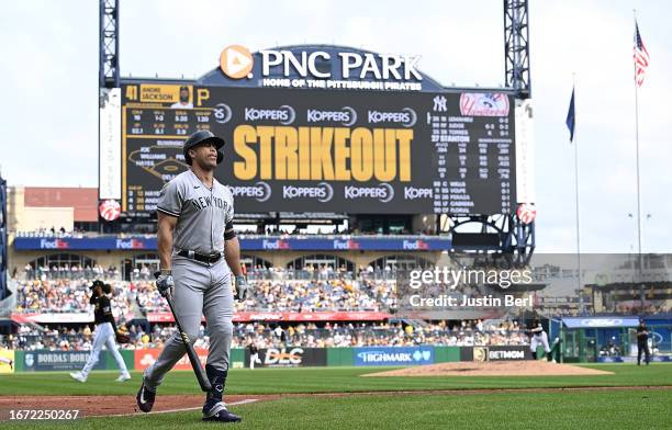 Giancarlo Stanton of the New York Yankees walks back to the dugout after striking out swinging in the fourth inning during the game against the...