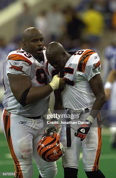 Defensive tackle Oliver Gibson of the Cincinnati Bengals consoles wide receiver Chad Johnson during the NFL game against the Indianapolis Colts at...