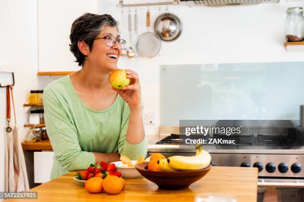 mature woman preparing fruit salad - stock photo - green apple slices stock pictures, royalty-free photos & images