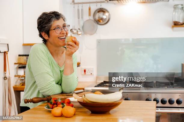 mature woman preparing fruit salad - stock photo - green apple slices stock pictures, royalty-free photos & images