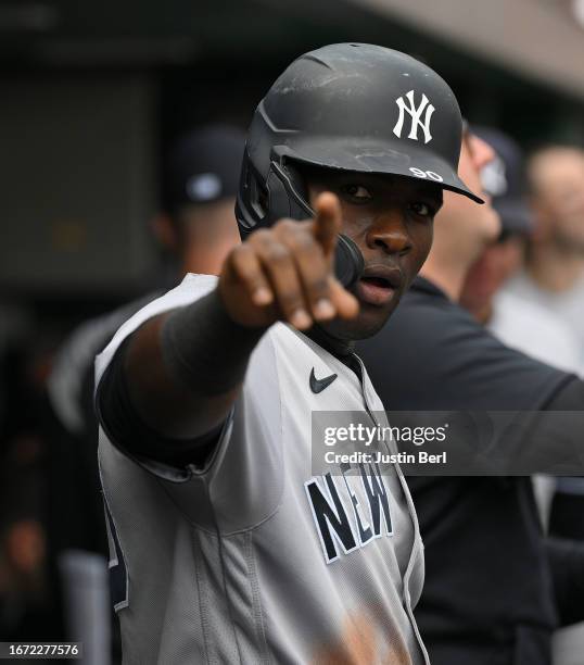 Estevan Florial of the New York Yankees celebrates in the dugout after coming around to score on a RBI double by DJ LeMahieu in the sixth inning...