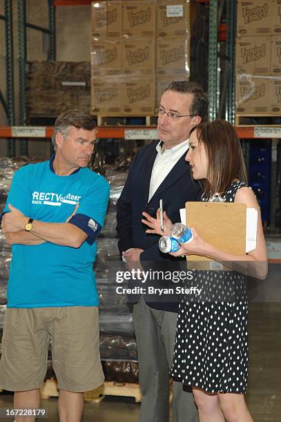 DirecTV CEO Mike White, Three Square Food Bank CEO Brian Buton and Three Square Food Bank Director of Corporate Giving Erica Thompson appear at Three...