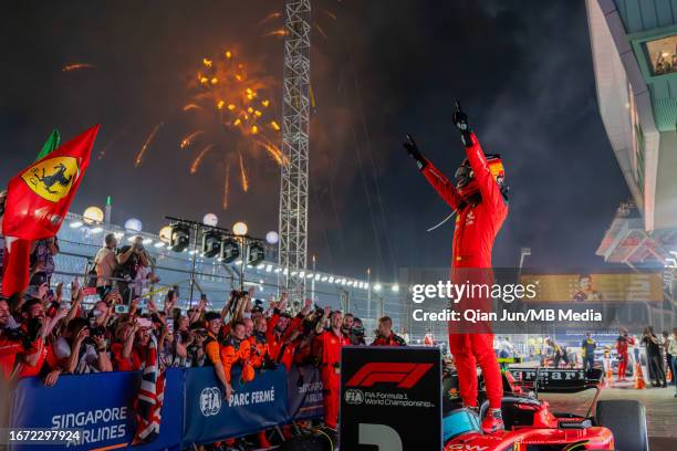 Carlos Sainz Jr of Spain and Scuderia Ferrari celebrates his win in parc feme during the F1 Grand Prix of Singapore at Marina Bay Street Circuit on...