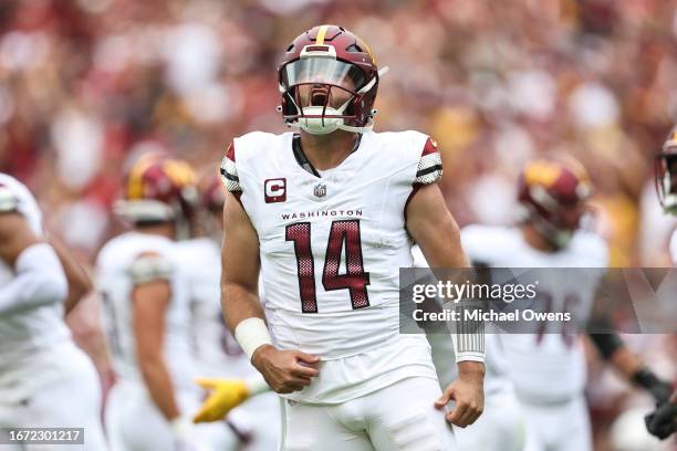Sam Howell of the Washington Commanders celebrates after passing for a touchdown against the Arizona Cardinals during a game at FedExField on...