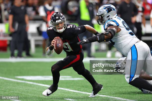 Derrick Brown of the Carolina Panthers sacks Desmond Ridder of the Atlanta Falcons during the second quarter at Mercedes-Benz Stadium on September...