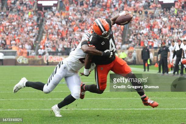 Deshaun Watson of the Cleveland Browns runs the ball past Chidobe Awuzie of the Cincinnati Bengals for a first half rushing touchdown at Cleveland...