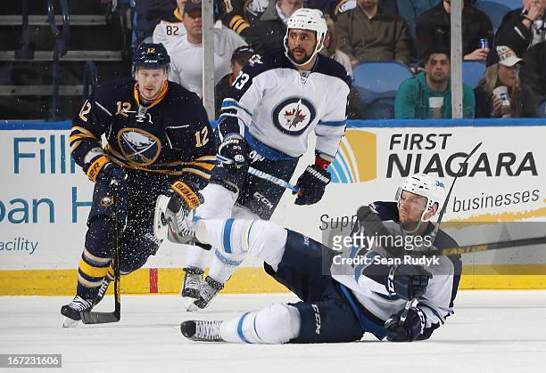 Aaron Gagnon of the Winnipeg Jets gets tripped up in front of Kevin Porter of the Buffalo Sabres at First Niagara Center on April 22, 2013 in...