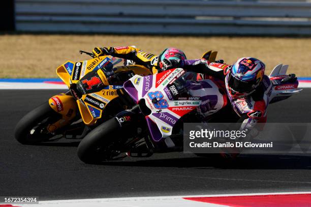 Jorge Martin of Spain and Prima Pramac Racing overtake Francesco Bagnaia of Italy and Ducati Lenovo Team during race of the MotoGP Of San Marino at...