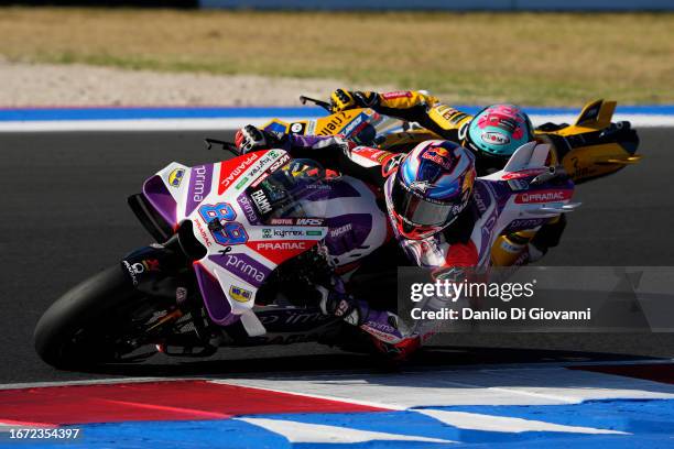 Jorge Martin of Spain and Prima Pramac Racing overtake Francesco Bagnaia of Italy and Ducati Lenovo Team during race of the MotoGP Of San Marino at...