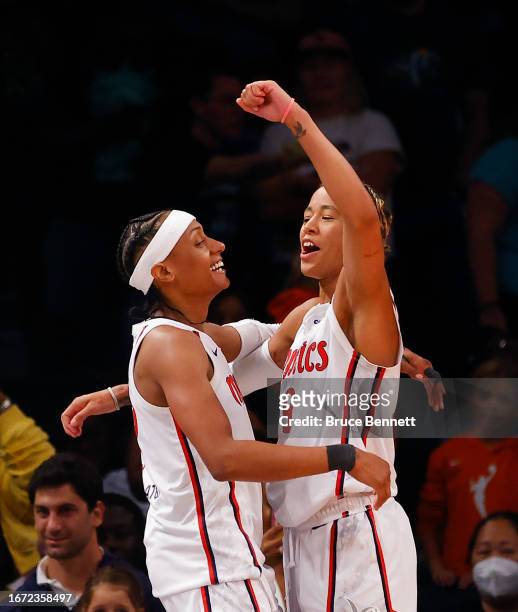 Brittney Sykes and 1 of the Washington Mystics celebrate their 90-88 victory over the New York Liberty at Barclays Center on September 10, 2023 in...
