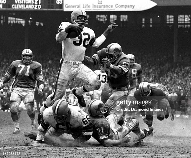 Fullback Jim Brown of the Cleveland Browns runs through the defense during a game on November 15, 1964 against the Detroit Lions at Cleveland...