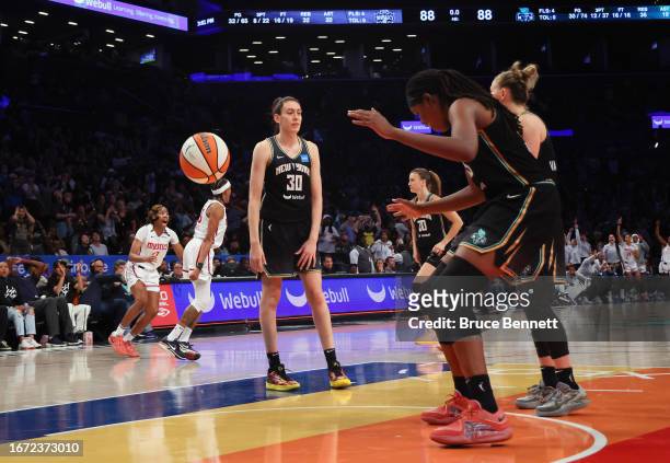 Brittney Sykes and the Washington Mystics celebrate her game winning basket against the New York Liberty at Barclays Center on September 10, 2023 in...