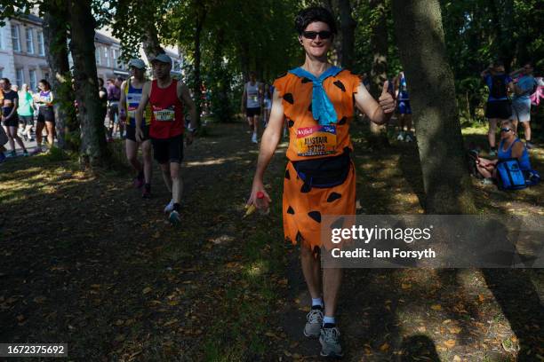 Runner dressed as the character Fred Flintstone waits in the shade at the start of the AJ Bell Great North Run on September 10, 2023 in Newcastle...