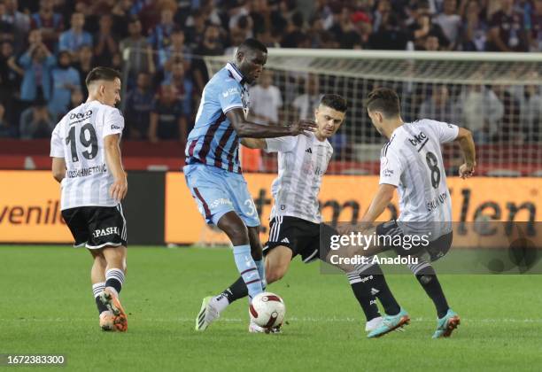 Onuachu of Trabzonspor in action against Milot Rachica and Salih Ucan of Besiktas during Turkish Super Lig soccer match between Trabzonspor and...