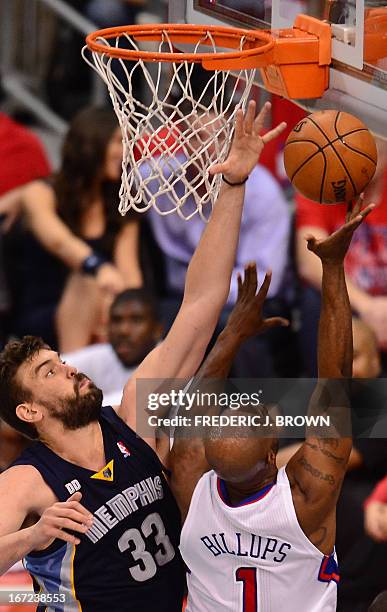 Chauncey Billups /R) of the Los Angeles Clippers is covered at the basket by Marc Gasol of the Memphis Grizzlies during game two of their NBA...