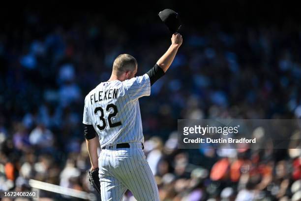 Chris Flexen of the Colorado Rockies tips his cap after a catch of a deep fly ball to end the fourth inning against the San Francisco Giants at Coors...