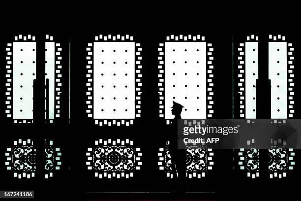 Chinese soldier stands guard at the main entrance door of the Bayi building where US Joint Chiefs Chairman General Martin Dempsey met with Chinese...