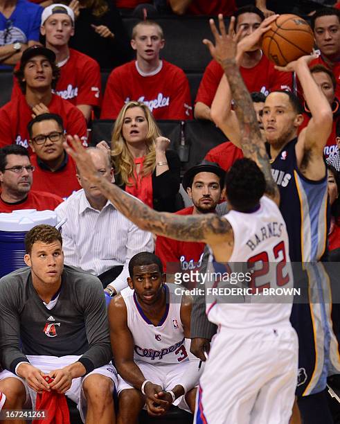 Blake Griffin and Chris Paul watch from the bench as teammate Matt Barnes covers Tayshaun Prince of the Memphis Grizzlies during game two of their...
