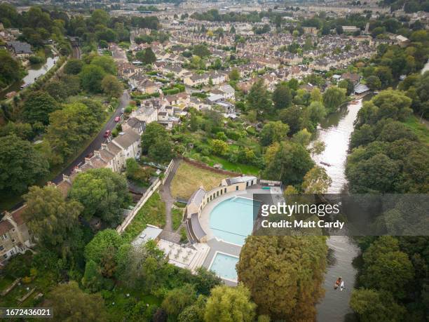The sun reflects on water in the main swimming pool at the outdoor Cleveland Pools lido viewed from a drone on September 10, 2023 in Bath, England....