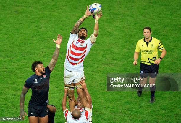 Japan's prop Amato Fakatava grabs the ball in a line out next to England's blindside flanker and captain Courtney Lawes during the France 2023 Rugby...