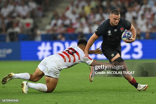 England's openside flanker Ben Earl breaks away from Japan's outside centre Tomoki Osada during the France 2023 Rugby World Cup Pool D match between...