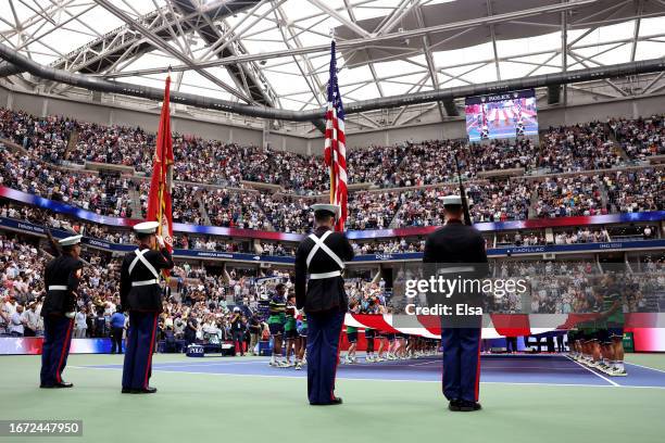 Large American flag is displayed over the court as American operatic baritone Will Liverman performs "America The Beautiful" prior to the Men's...