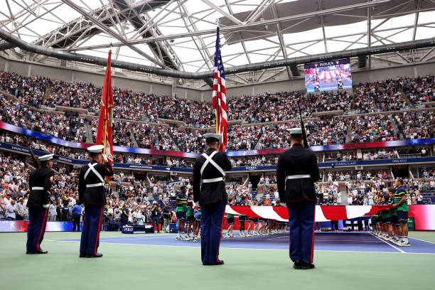 Large American flag is displayed over the court as American operatic baritone Will Liverman performs "America The Beautiful" prior to the Men's...