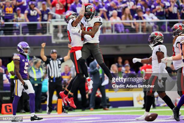 Trey Palmer of the Tampa Bay Buccaneers celebrates with Mike Evans after scoring a touchdown in the third quarter of a game against the Minnesota...