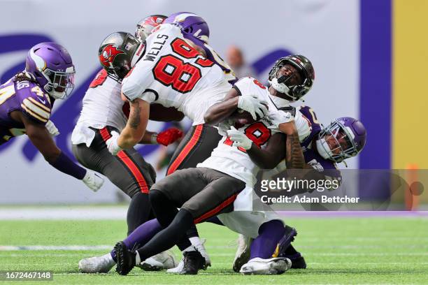 Ivan Pace Jr. #40 of the Minnesota Vikings tackles Rakim Jarrett of the Tampa Bay Buccaneers in the fourth quarter of a game at U.S. Bank Stadium on...