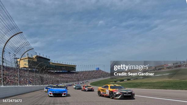 Christopher Bell, driver of the DEWALT Perform & Protect Toyota, and Kyle Larson, driver of the HendrickCars.com Chevrolet, lead the field on a pace...