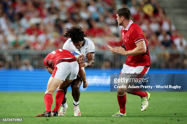 Selesitino Ravutaumada of Fiji is tackled by Josh Adams of Wales during the Rugby World Cup France 2023 match between Wales and Fiji at Nouveau Stade...