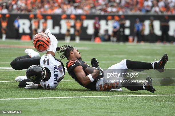 Baltimore Ravens Safety Kyle Hamilton pulls off the helmet of Cincinnati Bengals Wide Receiver Ja'Marr Chase during an NFL game between the Baltimore...