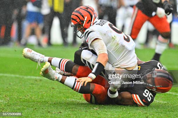 Joe Burrow of the Cincinnati Bengals is sacked by Myles Garrett of the Cleveland Browns during the second half at Cleveland Browns Stadium on...
