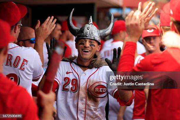 Friedl of the Cincinnati Reds celebrates with teammates in the dugout after hitting a home run during the seventh inning against the St. Louis...