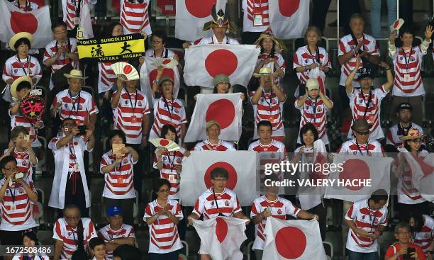 Japanese supporters hold flags at the end of the France 2023 Rugby World Cup Pool D match between England and Japan at Stade de Nice in Nice,...