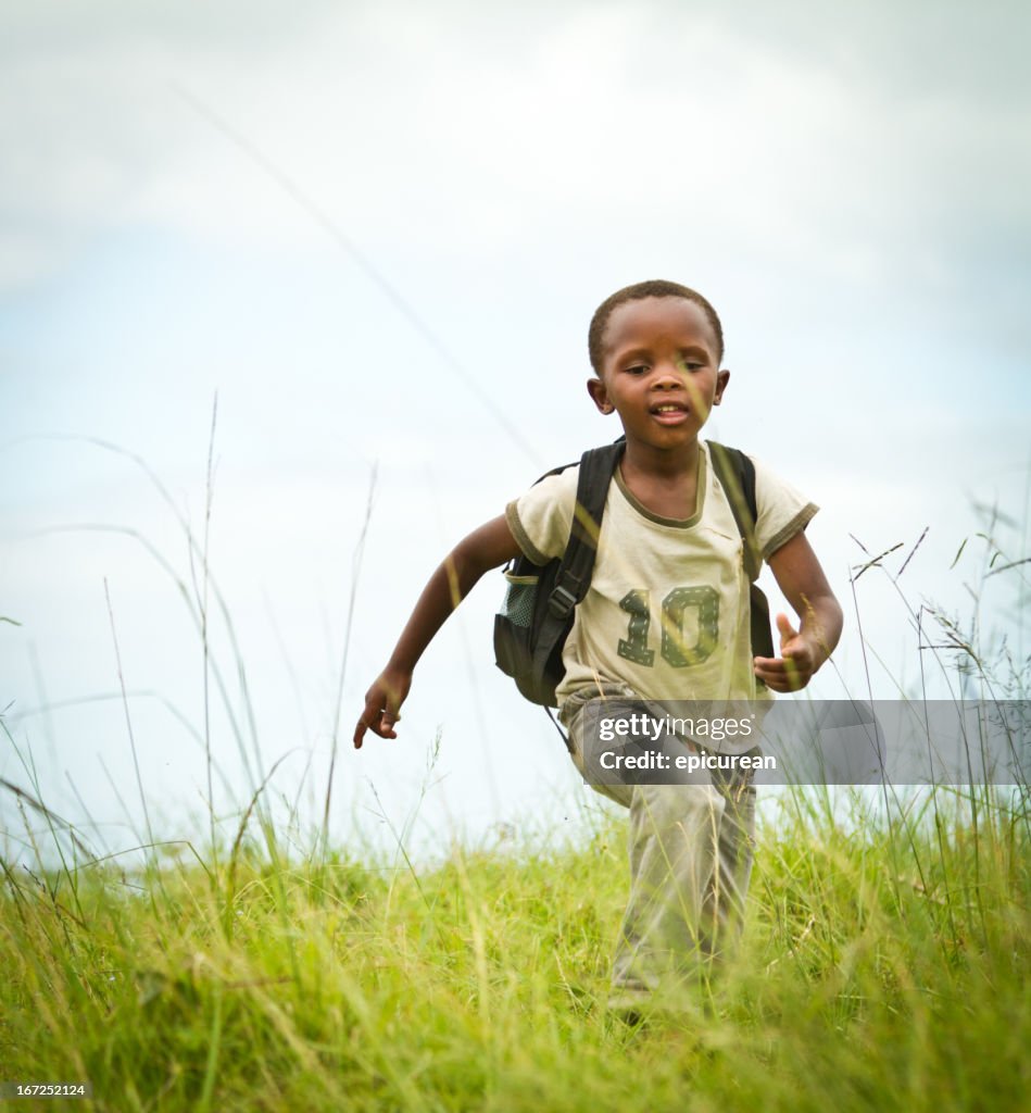 Happy Young South African Boy running to School
