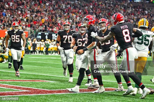 Atlanta quarterback Desmond Ridder and teammates react after Ridder scored a touchdown during the NFL game between the Green Bay Packers and the...