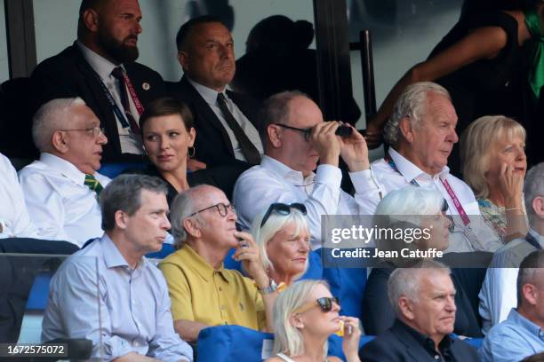 Princess Charlene of Monaco and Prince Albert II of Monaco - using his binoculars -, between Mark Alexander, president of the South African Rugby...