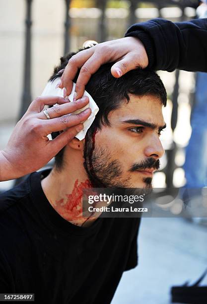 Student wounded during the police clashes is rescued by other students at Scuola Superiore Sant'Anna on April 23, 2013 in Pisa, Italy. Clashes...