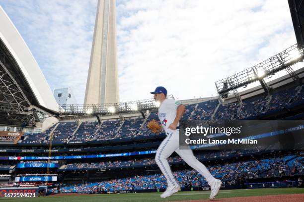 September 17 - Toronto Blue Jays second baseman Davis Schneider runs onto the field ahead of the start of the game against the Boston Red Sox in...