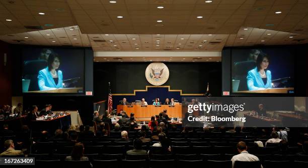 Deborah Hersman, chairman of the National Transportation Safety Board , on screen, speaks during a hearing at the NTSB in Washington, D.C., U.S., on...