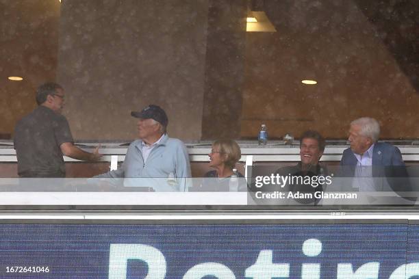 Former New England Patriots quarterback Tom Brady, black jacket, and New England Patriots owner Robert Kraft, blue jacket, watch a game between the...