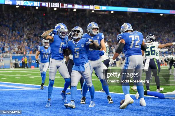 Running back David Montgomery of the Detroit Lions celebrates a touchdown during the second half of an NFL football game against the Seattle Seahawks...