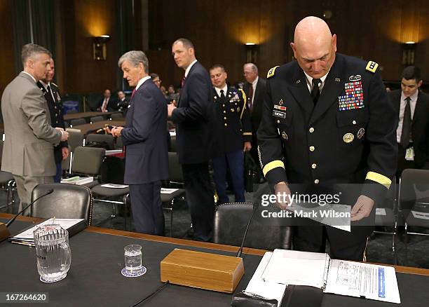 Chief of Staff of the U.S. Army Gen. Raymond Odierno looks over his papers before the start of a Senate Armed Services Committee hearing on April 23,...