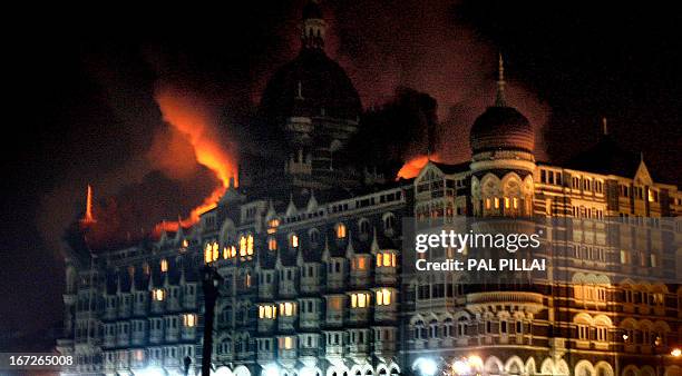 Fire breaks out of the dome of the Taj hotel in Mumbai on November 26, 2008. More than 80 people were killed in a series of attacks in the Indian...