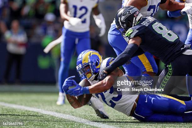 Kyren Williams of the Los Angeles Rams dives across the goal-line past Coby Bryant of the Seattle Seahawks for a rushing touchdown during the second...