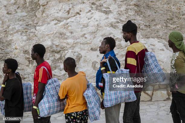 African migrants are seen before embarking the Lampedusa Ferry as the massive transfer of migrants is taking place from the Sicilian island of...