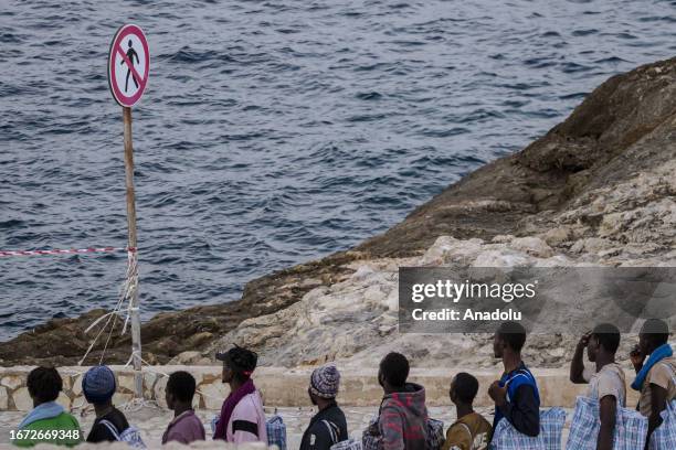 Migrants are seen before embarking the Lampedusa Ferry as the massive transfer of migrants is taking place from the Sicilian island of Lampedusa to...